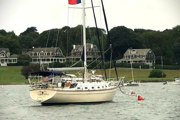 Slide: The Image of 2002 Island Packet 420 sailboat with blue canopy and clear enclosure at marina. - 14