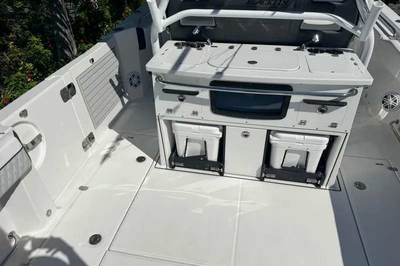 Slide: The Image of 2021 Blackfin 332 CC boat deck with storage compartments and seating area. - 10