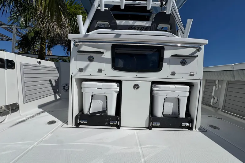 Slide: The Image of 2021 Blackfin 332 CC boat deck with storage compartments and coolers. - 14