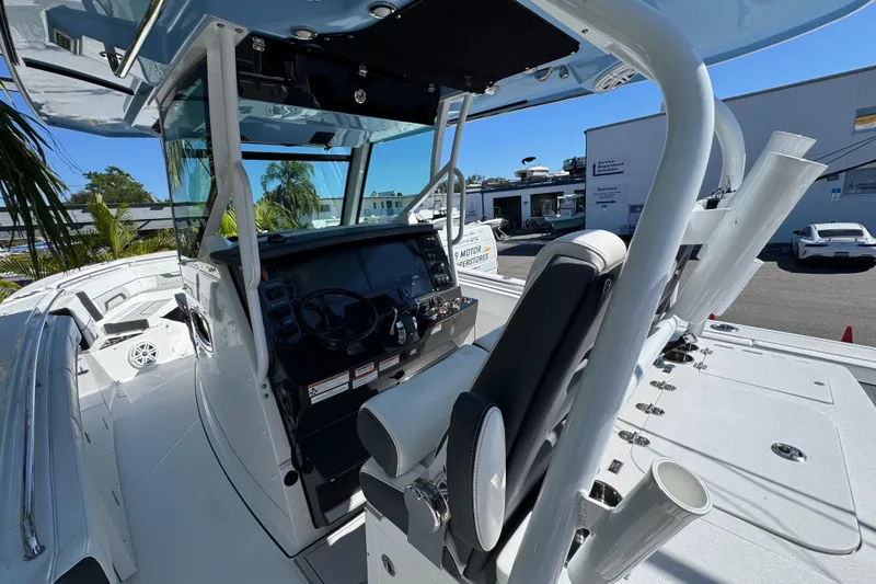 Slide: The Image of 2021 Blackfin 332 CC boat cockpit with steering wheel and seating. - 18