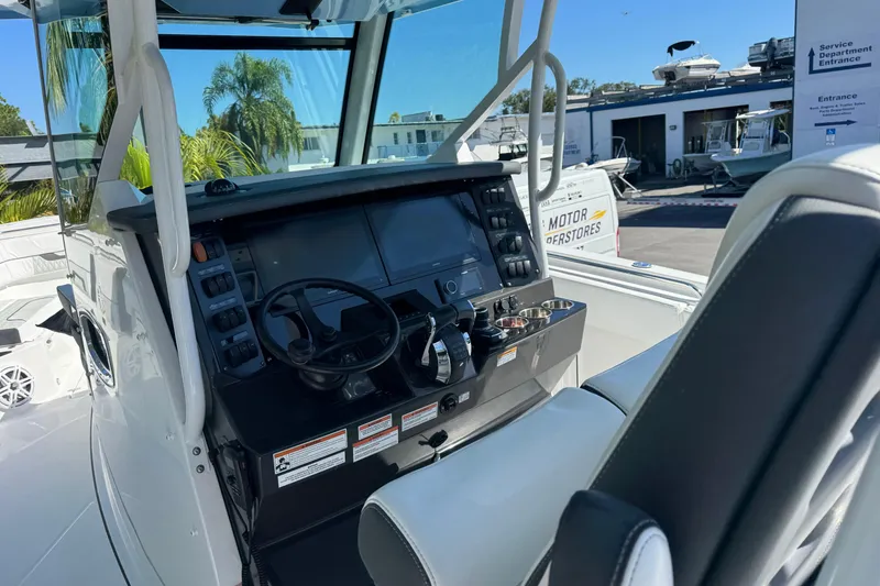 Slide: The Image of 2021 Blackfin 332 CC boat cockpit with steering wheel and control panel. - 19