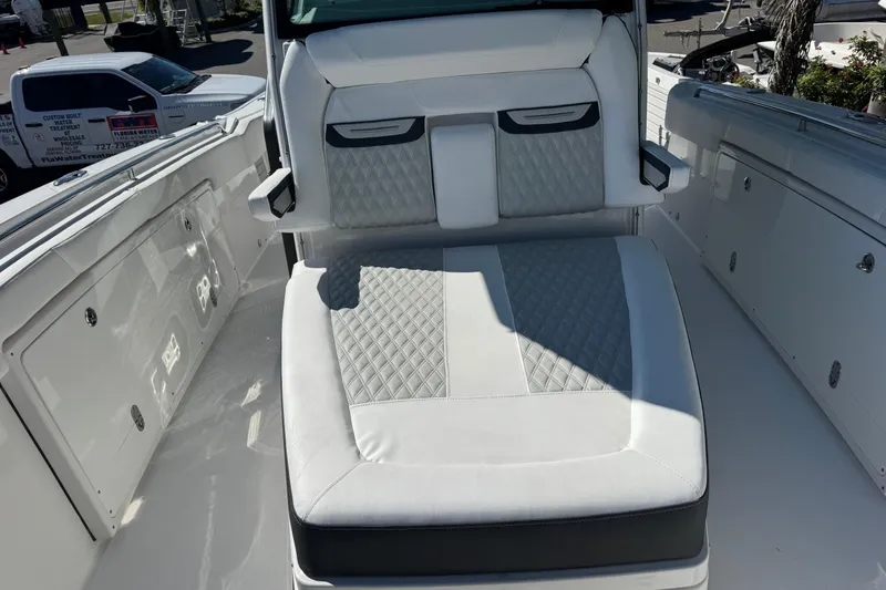 Slide: The Image of 2021 Blackfin 332 CC boat interior with cushioned seating and storage compartments. - 25
