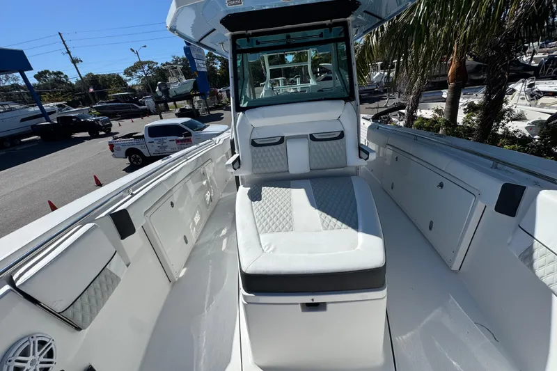 Slide: The Image of 2021 Blackfin 332 CC boat interior with white seating and storage compartments. - 26