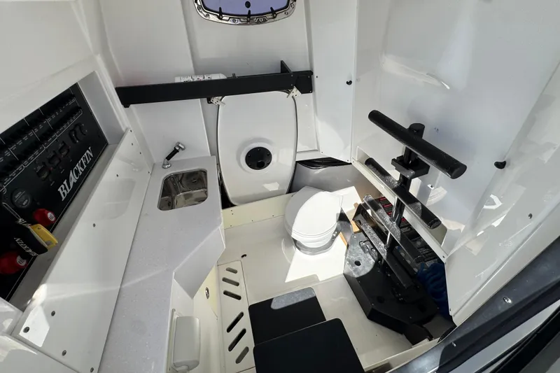 Slide: The Image of 2021 Blackfin 332 CC boat interior with sink, toilet, and storage area. - 31