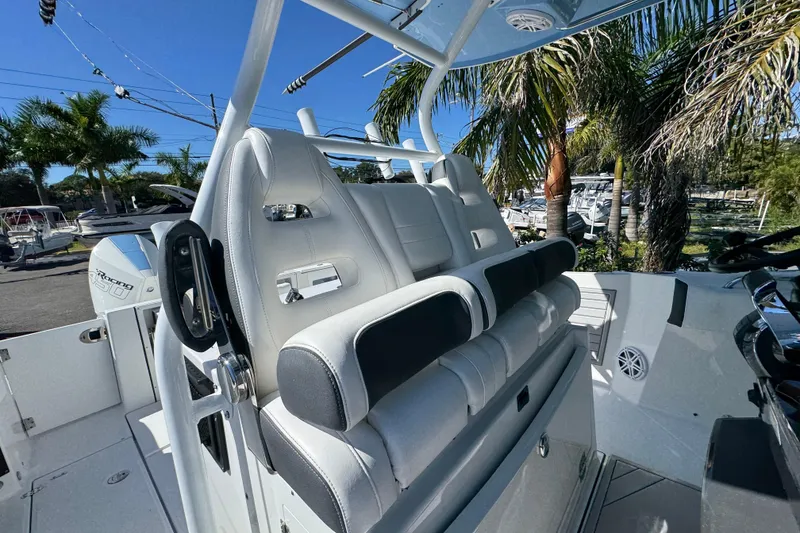 Slide: The Image of 2021 Blackfin 332 CC boat interior with luxurious seating and palm trees in the background. - 35