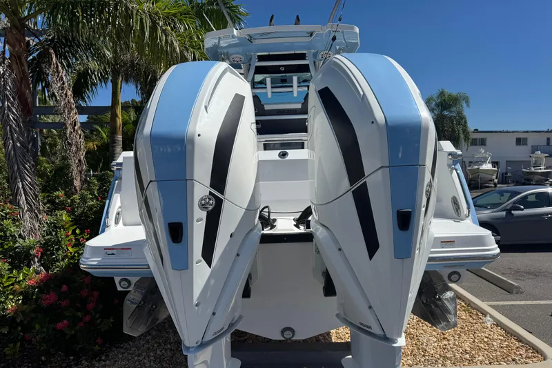 Slide: The Image of 2021 Blackfin 332 CC boat with dual outboard engines, parked outdoors. - 4