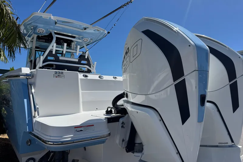 Slide: The Image of 2021 Blackfin 332 CC boat with dual outboard engines under clear blue sky. - 5