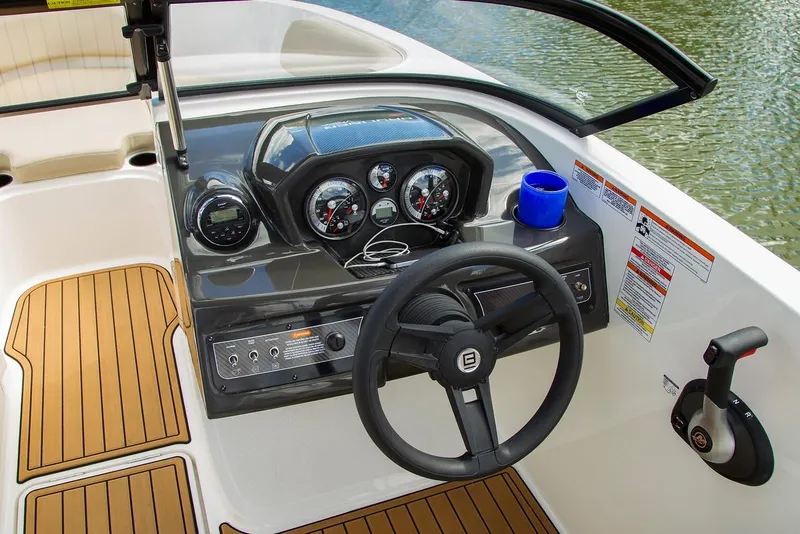 Slide: The Image of 2026 Bayliner VR6 Bowrider OB dashboard with steering wheel and controls. - 10