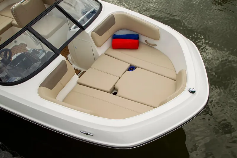 Slide: The Image of 2026 Bayliner VR6 Bowrider OB with beige seating and red-blue cushion on water. - 11
