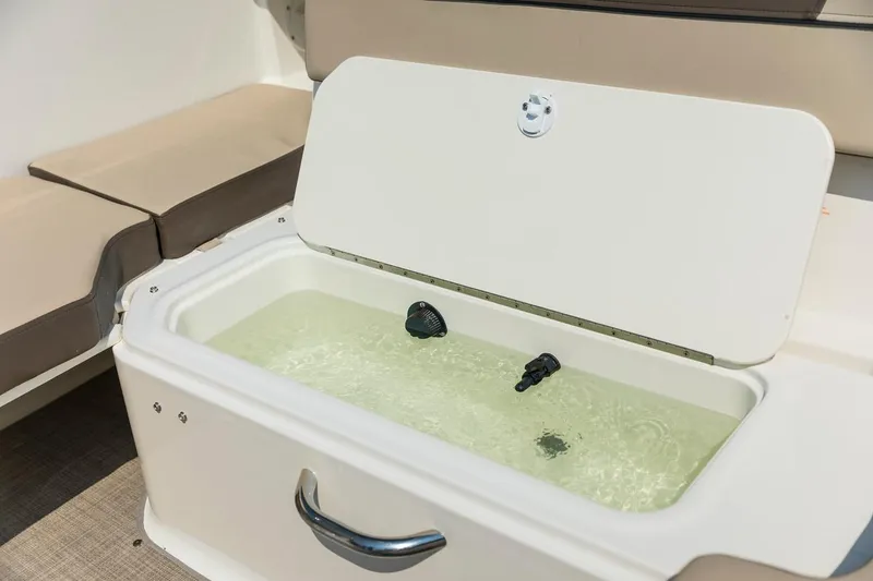 Slide: The Image of 2026 Bayliner VR6 Bowrider OB livewell with open lid and water inside. - 14