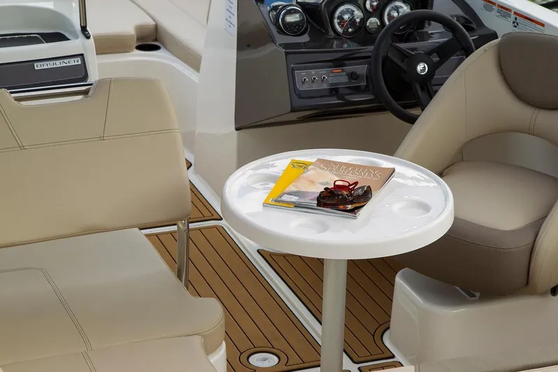 Slide: The Image of Interior of 2026 Bayliner VR6 Bowrider OB with seating, table, and dashboard. - 8