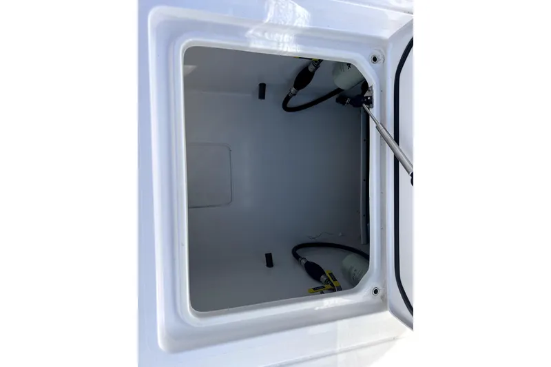 Slide: The Image of 2024 Contender 32 ST storage compartment with hydraulic struts and hoses. - 14