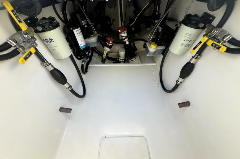 Slide: The Image of 2024 Contender 32 ST boat engine compartment with fuel filters and hoses. - 15