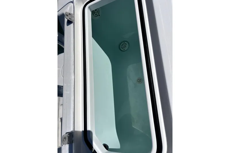 Slide: The Image of 2024 Contender 32 ST boat storage compartment, open lid, showing interior details. - 20
