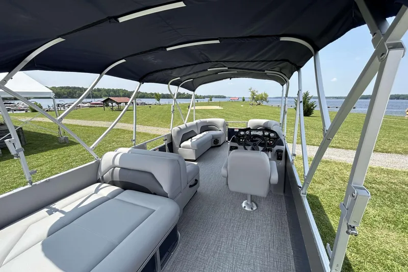 Slide: The Image of 2023 Landau Island Breeze 232 Cruise pontoon boat interior with seating and helm. - 11