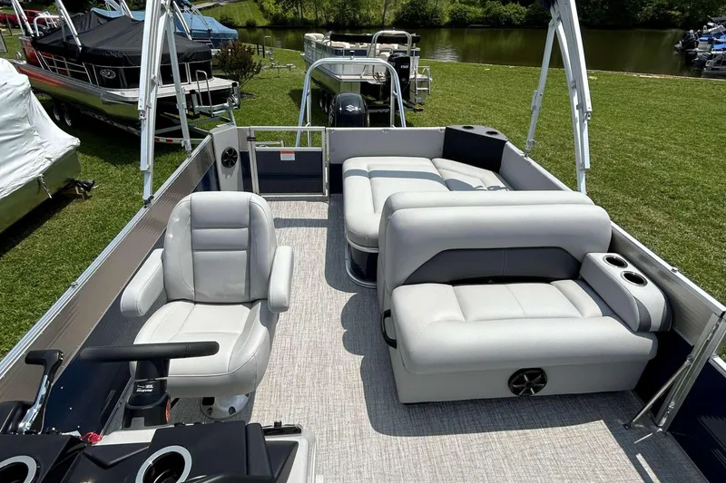 Slide: The Image of 2023 Landau Island Breeze 232 Cruise pontoon boat interior with plush seating and helm. - 5