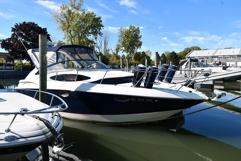 The Image of 2005 Regal 3060 Window Express boat docked in a marina under a clear blue sky. - 0