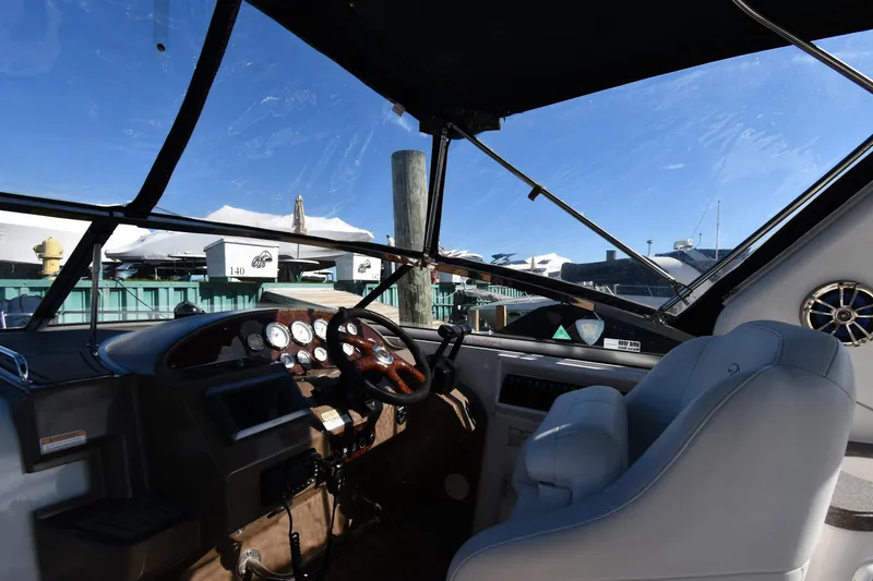 Slide: The Image of Interior view of 2005 Regal 3060 Window Express boat cockpit with steering wheel and gauges. - 10