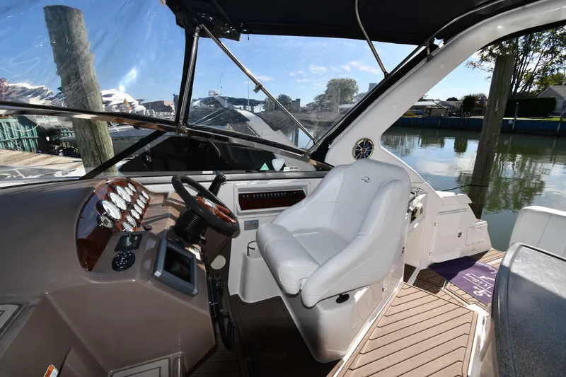 Slide: The Image of 2005 Regal 3060 Window Express boat interior with steering wheel and captain's chair. - 13