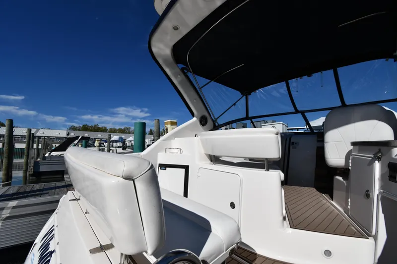Slide: The Image of 2005 Regal 3060 Window Express boat interior with white seating and clear blue sky. - 16