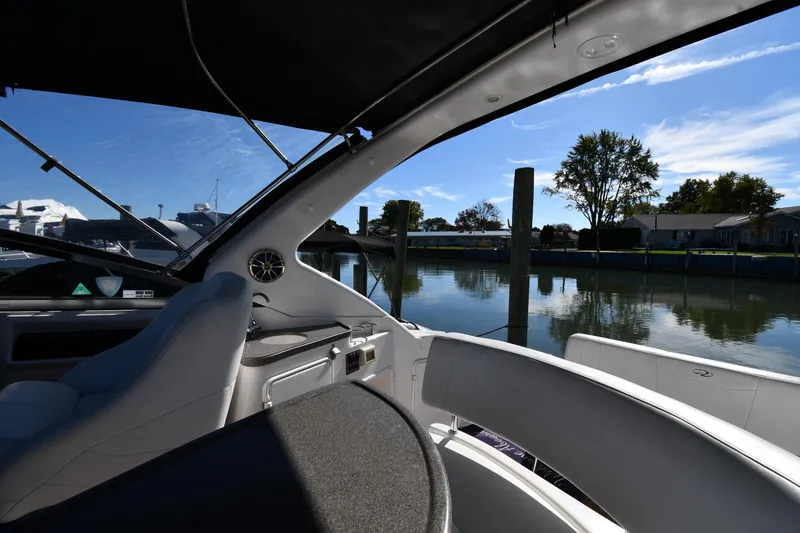 Slide: The Image of Interior view of 2005 Regal 3060 Window Express boat docked by calm waters. - 18