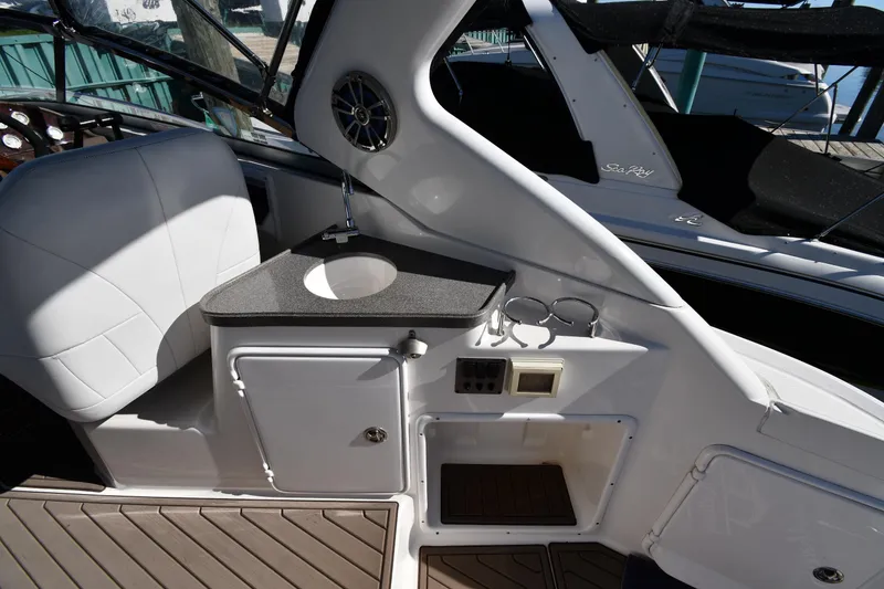 Slide: The Image of 2005 Regal 3060 Window Express boat interior with sink and seating area. - 19
