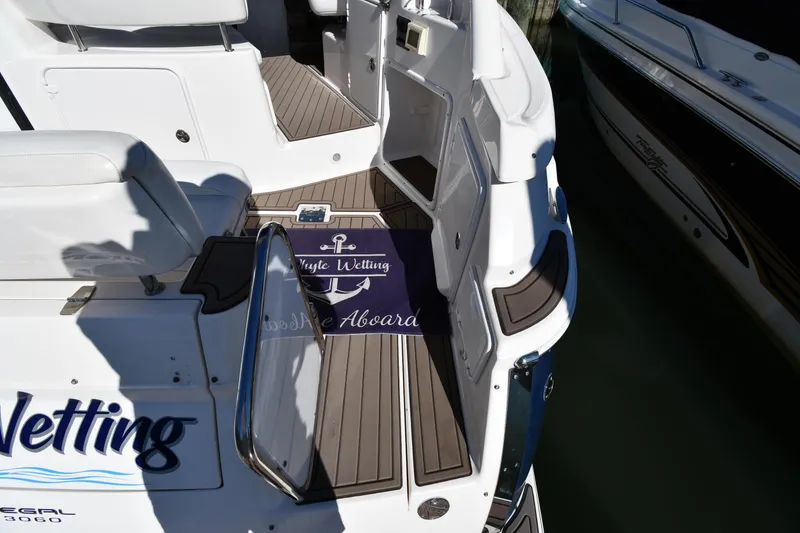 Slide: The Image of 2005 Regal 3060 Window Express boat deck with welcome mat and seating area. - 21