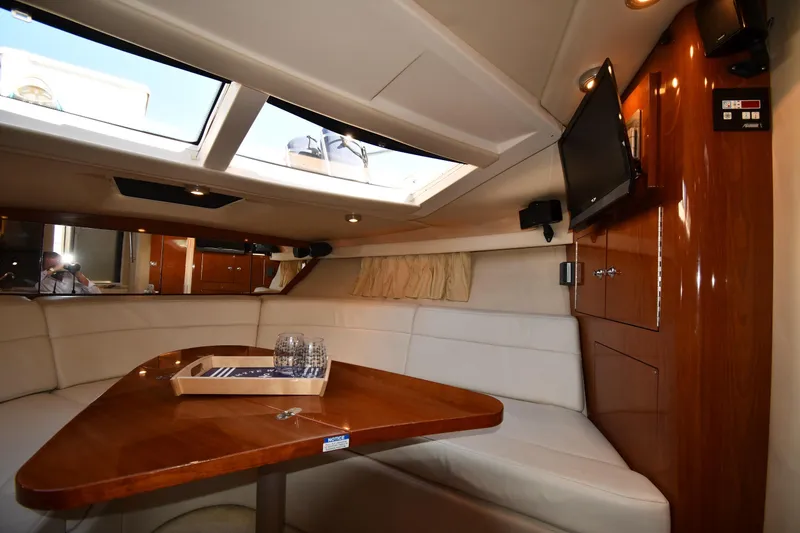 Slide: The Image of 2005 Regal 3060 Window Express cabin interior with skylights, wooden table, and seating area. - 27