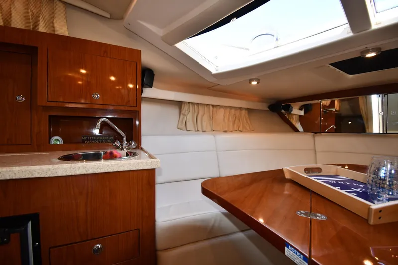 Slide: The Image of Luxurious interior of 2005 Regal 3060 Window Express yacht with kitchenette and seating area. - 28