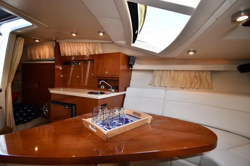 Slide: The Image of Luxurious interior of 2005 Regal 3060 Window Express yacht with kitchenette and seating area. - 29