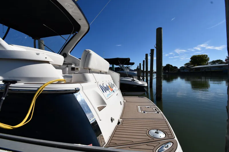 Slide: The Image of 2005 Regal 3060 Window Express docked on a sunny day, calm waters. - 3