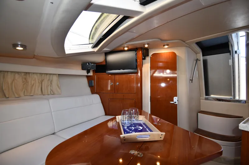 Slide: The Image of Luxurious interior of 2005 Regal 3060 Window Express yacht with elegant seating and wooden finishes. - 30