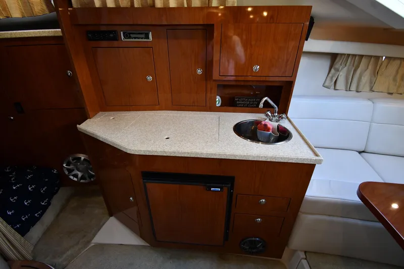 Slide: The Image of 2005 Regal 3060 Window Express boat interior with kitchenette and sink. - 31