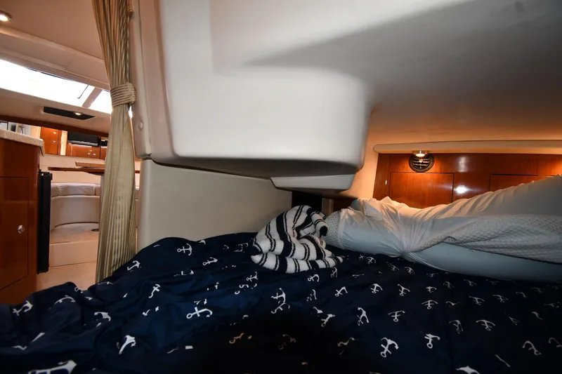 Slide: The Image of 2005 Regal 3060 Window Express cabin interior with cozy bedding and nautical decor. - 40