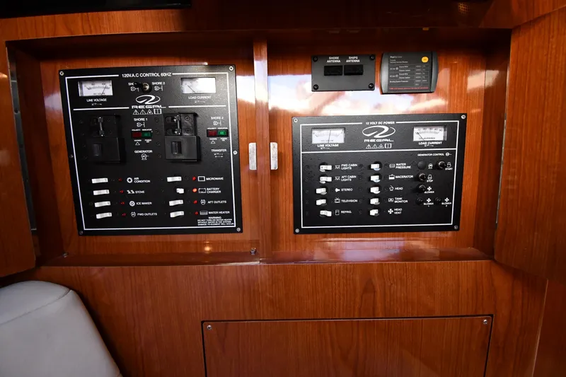 Slide: The Image of Control panel of a 2005 Regal 3060 Window Express boat, featuring various switches and gauges. - 42