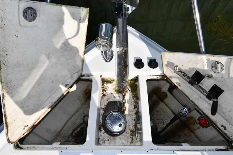 Slide: The Image of 2005 Regal 3060 Window Express boat anchor compartment with open hatches and visible equipment. - 5