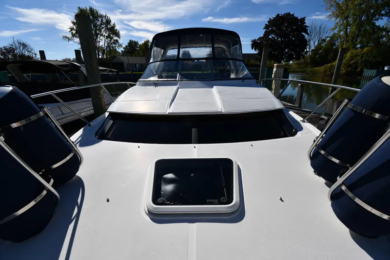 Slide: The Image of 2005 Regal 3060 Window Express boat docked, featuring sleek design and spacious deck. - 6