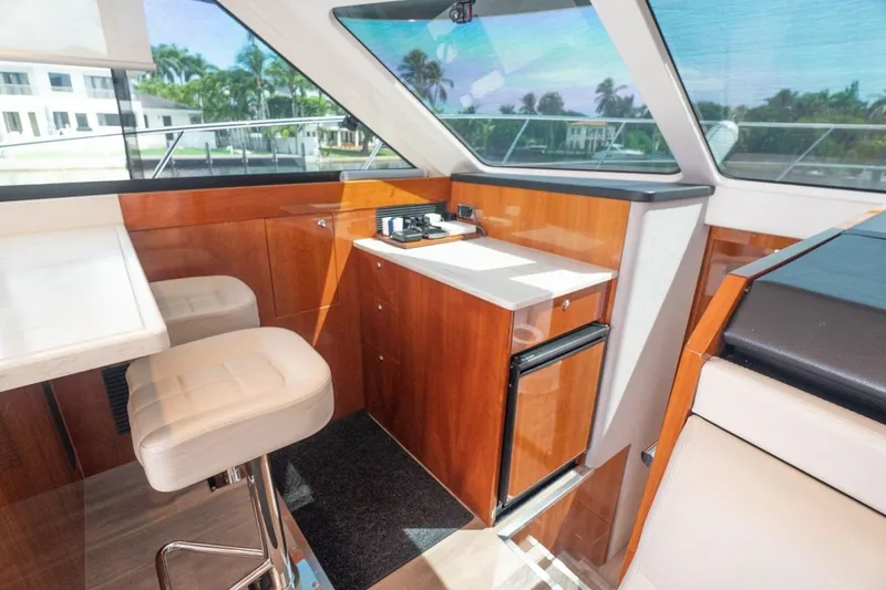 Slide: The Image of Interior of 2018 Riviera 43 Open Flybridge yacht with modern seating and cabinetry. - 12