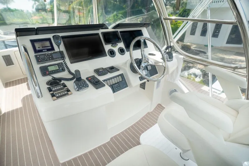 Slide: The Image of Helm of 2018 Riviera 43 Open Flybridge with advanced navigation controls and steering wheel. - 7
