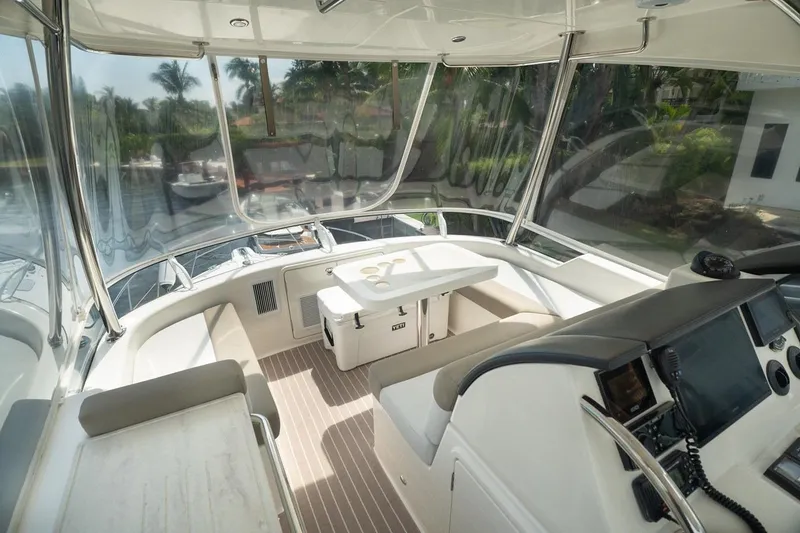 Slide: The Image of 2018 Riviera 43 Open Flybridge interior with helm, seating, and navigation equipment. - 9