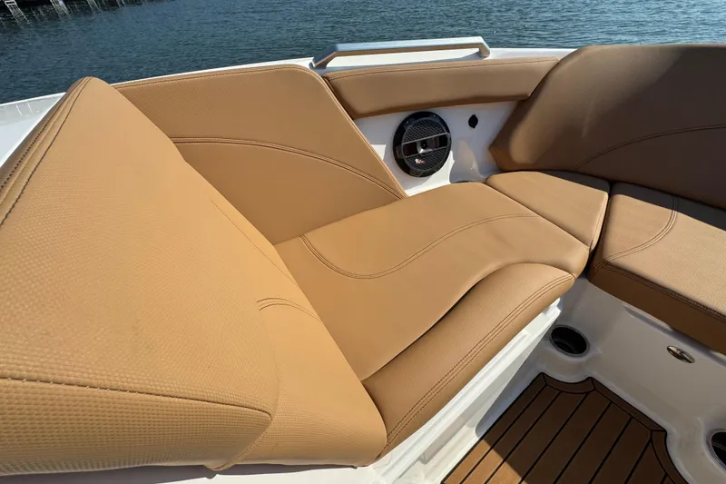 Slide: The Image of Luxurious tan seating on 2021 MasterCraft XT22 boat, featuring premium upholstery and speaker system. - 11