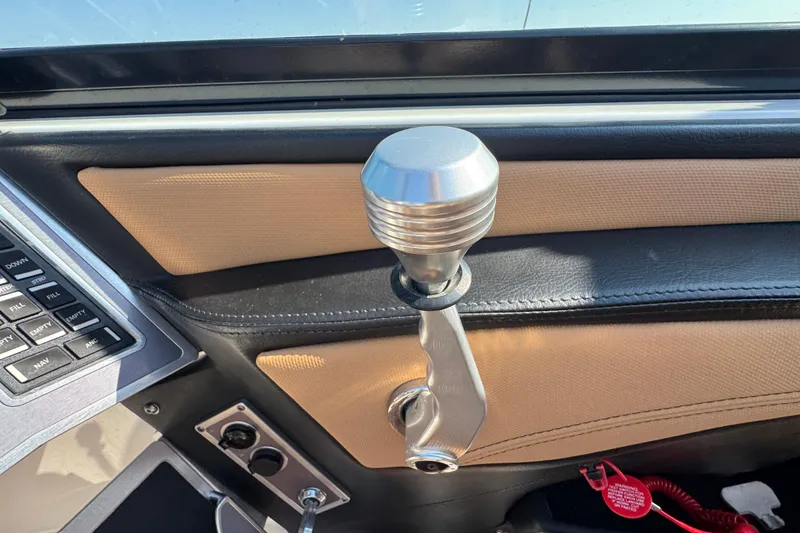 Slide: The Image of 2021 MasterCraft XT22 boat interior with gear shift lever and control panel. - 18