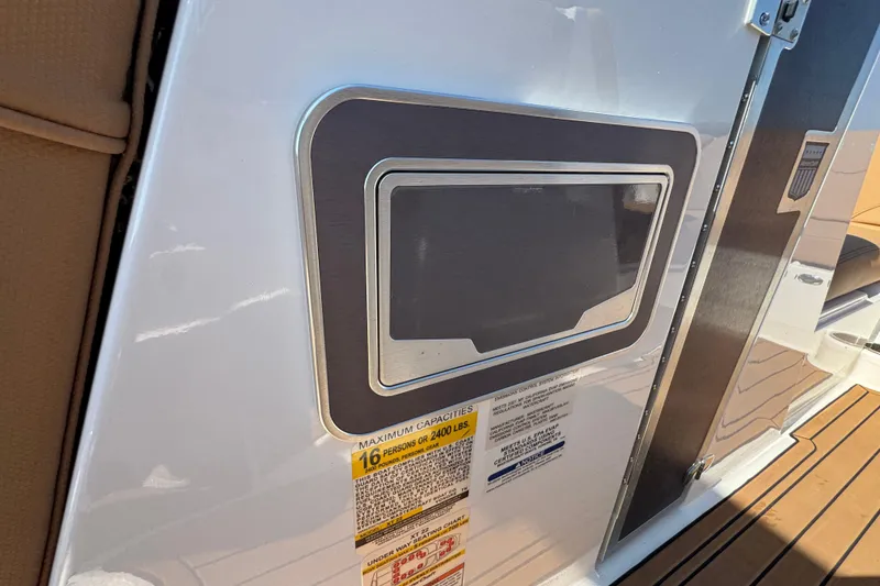 Slide: The Image of 2021 MasterCraft XT22 boat interior with capacity label and sleek design details. - 19