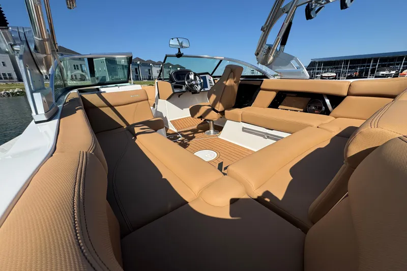 Slide: The Image of 2021 MasterCraft XT22 boat interior with tan seating and modern dashboard. - 22