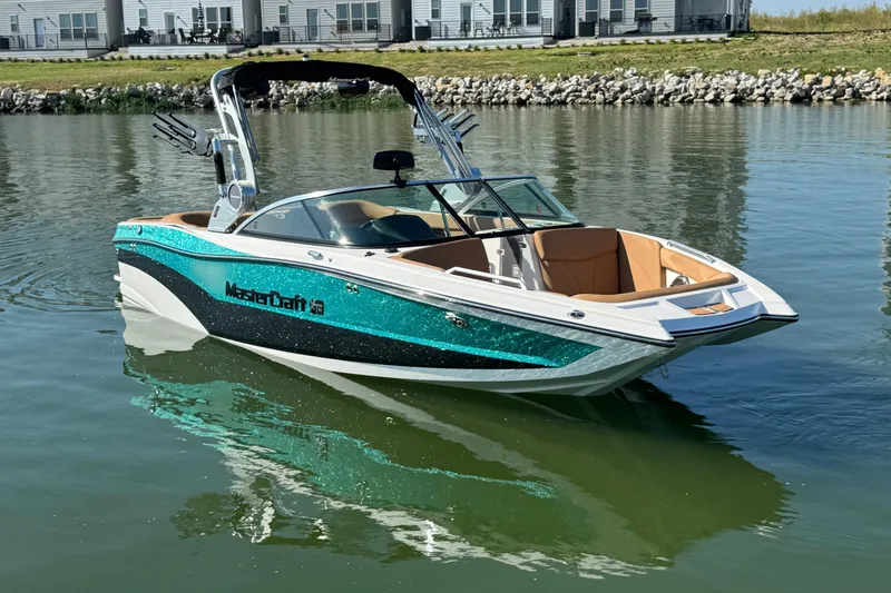 Slide: The Image of 2021 MasterCraft XT22 boat on calm water, featuring sleek design and vibrant colors. - 3