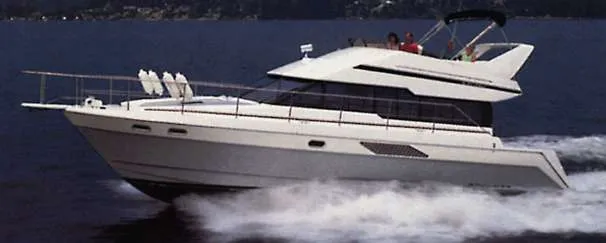 The Image of 1990 Bayliner 4388 Motoryacht docked in a covered marina. - 0