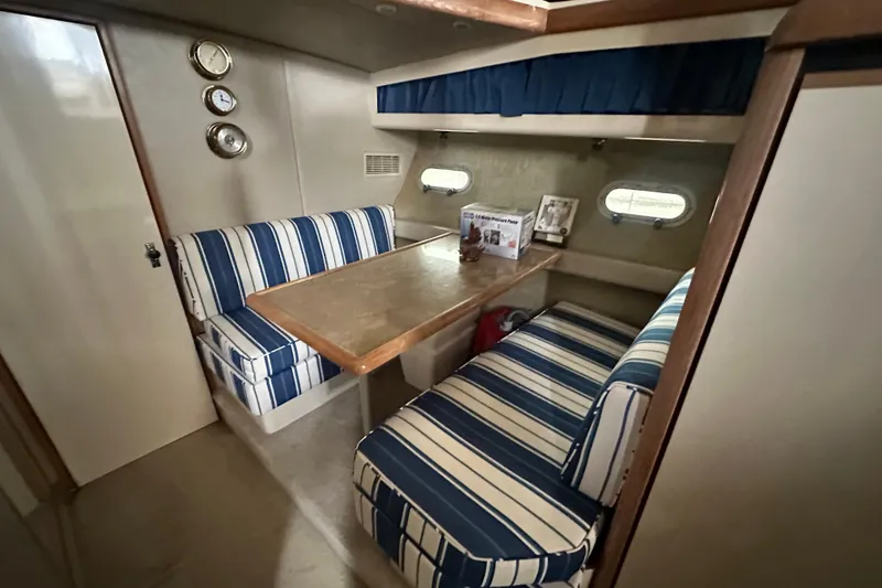 Slide: The Image of 1990 Bayliner 4388 Motoryacht interior with seating, sink, and ladder. - 11