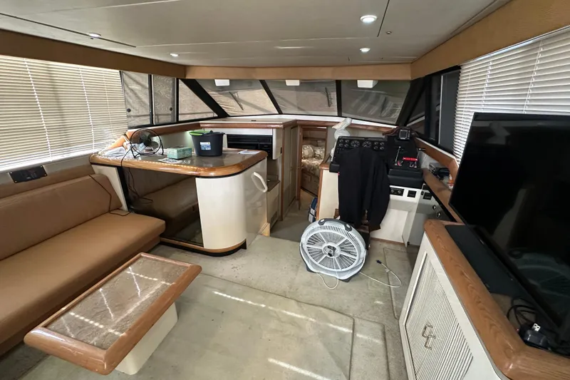 Slide: The Image of Interior of 1990 Bayliner 4388 Motoryacht with seating, table, and helm station. - 19