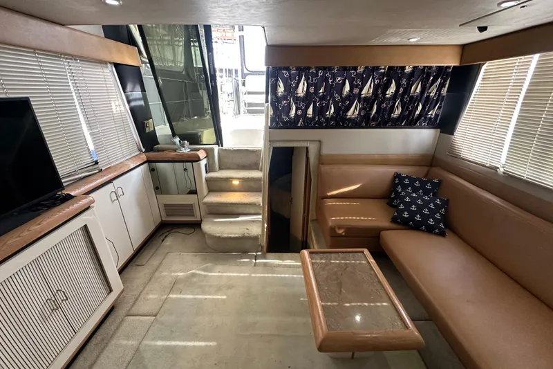 Slide: The Image of Interior of 1990 Bayliner 4388 Motoryacht with cozy seating and nautical decor. - 21
