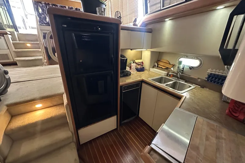 Slide: The Image of 1990 Bayliner 4388 Motoryacht kitchen with modern appliances and wooden flooring. - 25